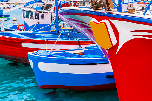 Colourful fishing trawlers and smaller boats moored in harbour, Tenerife, Spain.