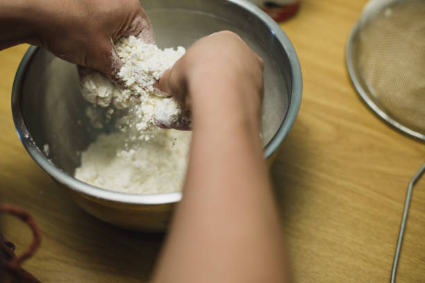 istock Mixing butter into flour by hand 1223951350