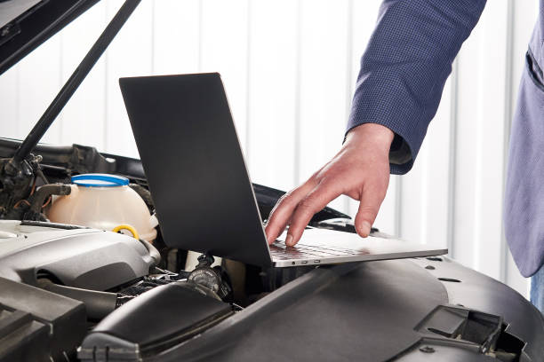 istock Car mechanic using computer in auto repair shop 1223952907