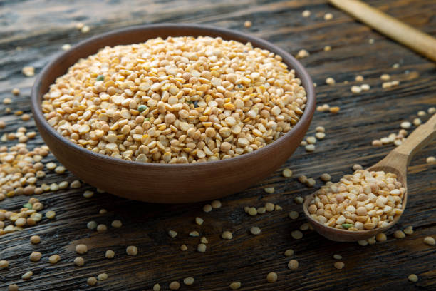 istock dry yellow peas in a plate on a brown wooden table 1223954704