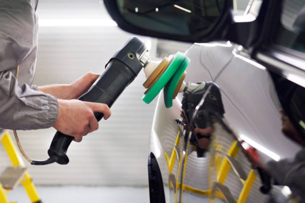 istock Man using polisher to polish black car body in the workshop 1223954906
