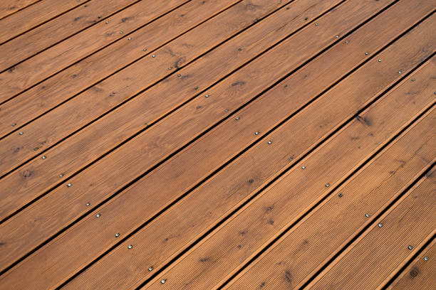 istock Natural outdoors wooden board floor. Brown floor fixed with screws pins. 1223955135