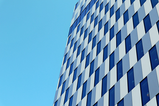 Business center building cubic architecture background. Blue cells and sky modern design in urban exterior details. Steel and sky construction skyscraper in Helsinki, Finland