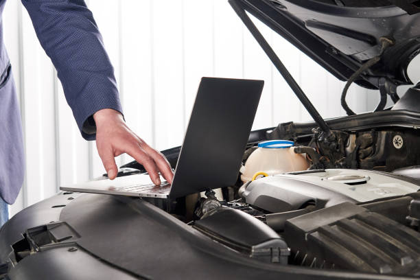 istock Car mechanic using computer in auto repair shop 1223957294