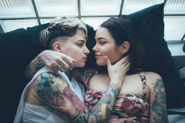 istock Lesbian couple lying in bed, embracing each other 1223957516