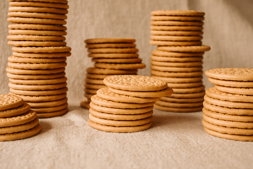 Heap of wheat biscuits as background and texture for design. Delicious cereal biscuits ready to eat. Breakfast concept.