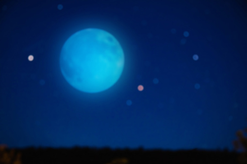 Full blue Moon on a starry skies. De-focused photo.