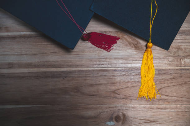 istock Black university graduate hat placed on a wooden floor 1223963851