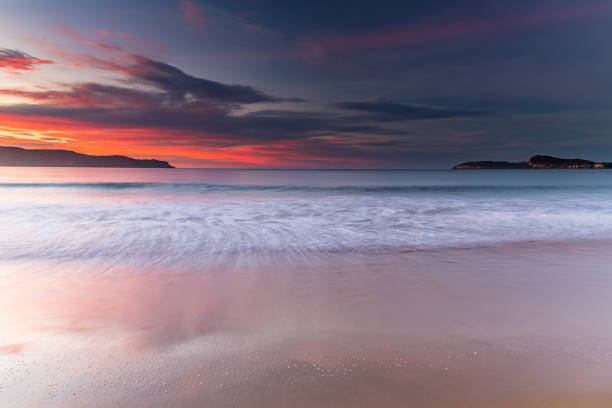 istock Sunrise at the Beach with Clouds 1223964522