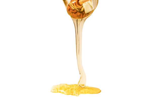 istock Dipper with honey on a white background. 1223965690