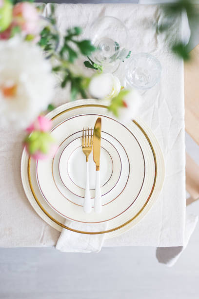 istock Wedding table setting with flowers and golden fork and knife 1223967404