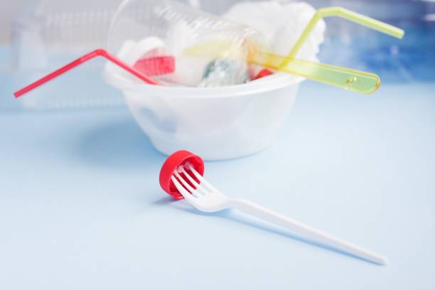 istock Fork with bottle cap against pile of single use plastic garbage. Concept of environmental pollution with plastic. 1223967514