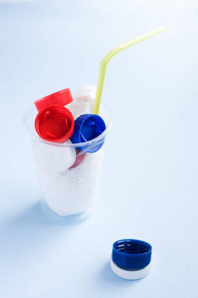 istock Danger cocktail from plastic bag and bottle caps with colorful straw against plastic. Concept of environmental pollution with plastic. 1223967533