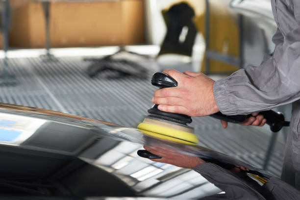 istock hands holding polisher to polish car in auto workshop 1223968646
