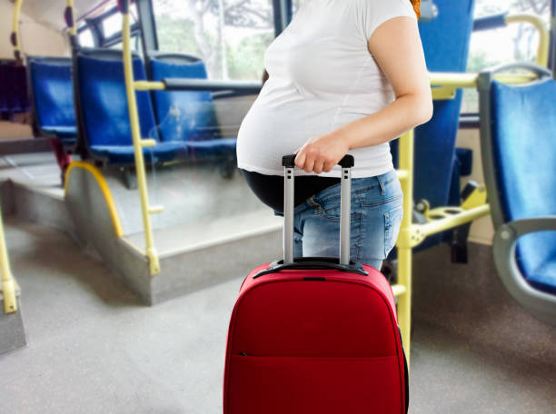 pregnant woman travelling by bus
