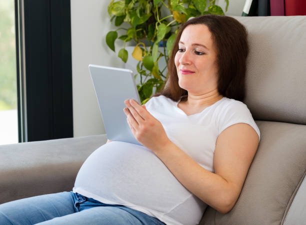 istock pregnant woman using tablet 1223969345