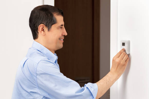 istock business man push button digital thermostat 1223969498