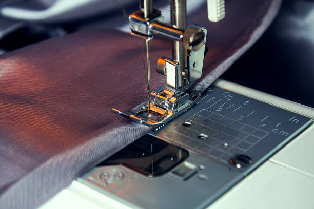 istock A man hem a curtain on a sewing machine. Sewing, hobbies, hobby, home improvement. 1223969504