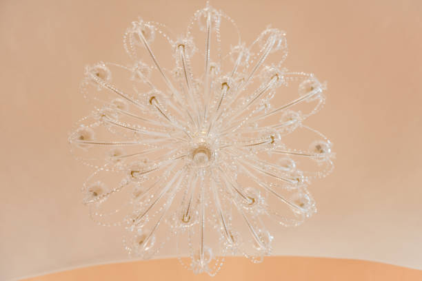 chandelier lit on ceiling in shape of a snowflake