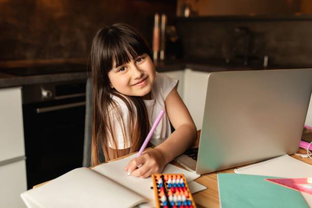 istock Online learning, schoolgirl studying homework during her online lesson at home 1223971199