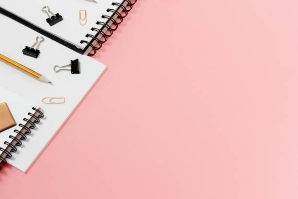 istock Mockup planner flat lay, top horizontal view pink background. Notepad and notebooks with stationary. Golden, white, pink and black colors 1223971795