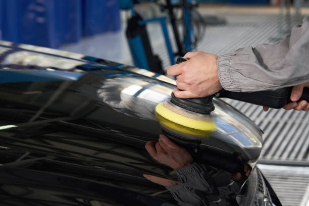 istock Man using polisher to polish black car body in the workshop 1223971957
