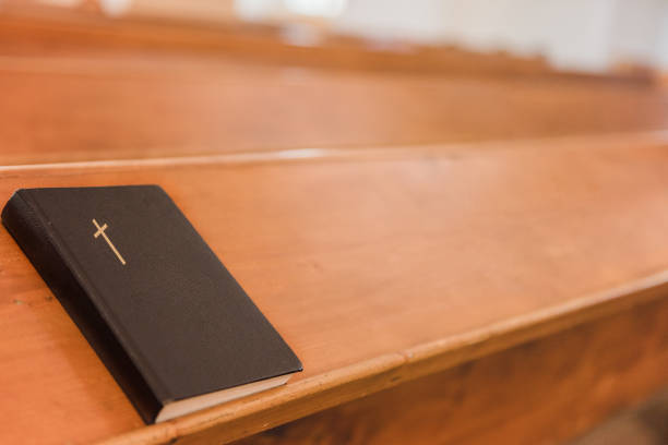 istock bible praying book on a church table bench 1223973056
