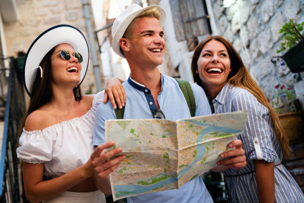 istock Happy traveling tourists sightseeing with map in hand 1223974973