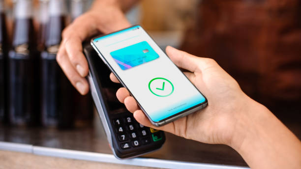 istock Young Woman is Using Contactless NFC Payment App Installed on Her Smartphone to Pay for Gourme Street Food. Eco Friendly Gluten Free Food Court Selling Modern Fusion Cuisine 1223977290