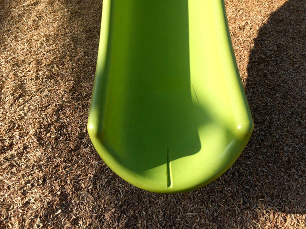 istock New modern Playground equipment green plastic slide at park school 1223978533