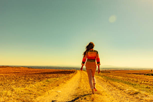 istock Woman walking on a dirt road 1223979258