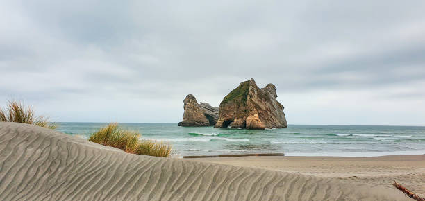 istock Wharariki beach and Archway rocks 1223985446