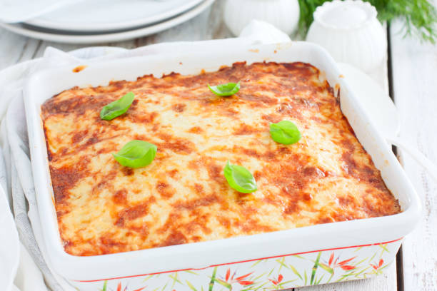 istock Potato casserole with minced meat in a square ceramic form on a wooden table, selective focus 1223985852