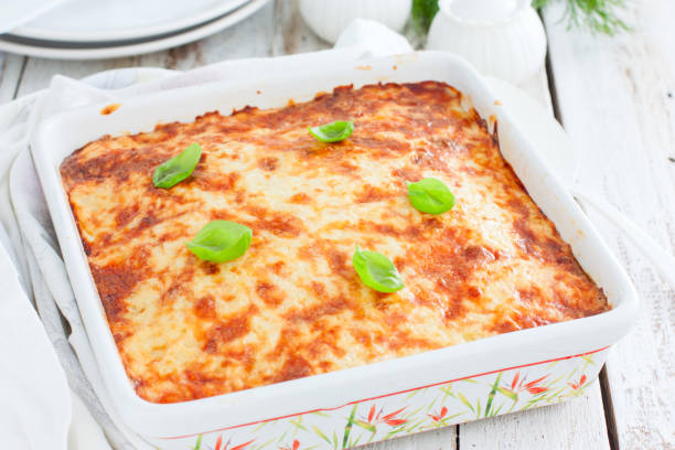 istock Potato casserole with minced meat in a square ceramic form on a wooden table, selective focus 1223985908