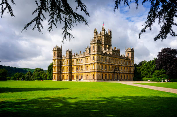 Highclere Castle - Downton Abbey Hampshire, England, UK - 4th August, 2012: Highclere Castle is an English country residence circa 1600 which has become known to millions around the world as Downton Abbey from the TV series of the same name. Now a major tourist attraction around 1,200 people per day visit this iconic location to enjoy the splendour of the house and walk in the footsteps of the much actors much loved by their fans. hampshire england photos stock pictures, royalty-free photos & images