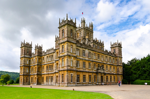 Hampshire, England, UK - 4th August, 2012: Highclere Castle is an English country residence circa 1600 which has become known to millions around the world as Downton Abbey from the TV series of the same name. Now a major tourist attraction around 1,200 people per day visit this iconic location to enjoy the splendour of the house and walk in the footsteps of the much actors much loved by their fans.
