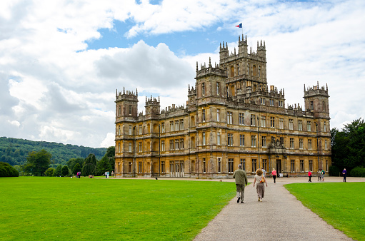 Hampshire, England, UK - 4th August, 2012: Highclere Castle is an English country residence circa 1600 which has become known to millions around the world as Downton Abbey from the TV series of the same name. Now a major tourist attraction around 1,200 people per day visit this iconic location to enjoy the splendour of the house and walk in the footsteps of the much actors much loved by their fans.