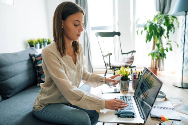 istock Young businesswoman disinfecting keyboard before work 1223988039