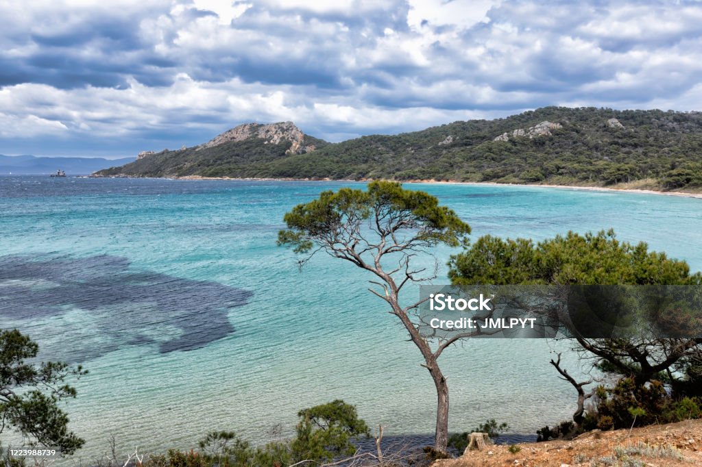 The island of Porquerolles in the Var, in Provence, on the Côte d'Azur The island of Porquerolles is the largest and most western of the three islands of Hyères with its 12.54 km² of surface. It is located 2.6 km southeast of the Fondue Tower, the southern end of the Giens peninsula, and 9.6 km west of the island of Port-Cros.

This is the beach of Notre Dame. Hidden behind a wood, sheltered from the wind, this beautiful white sand beach located north of the island of Porquerolles is fascinatingly beautiful.
Less crowded than the other beaches of the island, Notre-Dame beach extends for nearly 800 meters. Then you will be quiet to rest, contemplate the landscape and swim in the turquoise blue sea.
This amazing island is the largest and most western of the three islands of Hyères. According to European Best Destinations, an organization that promotes culture and tourism in the Old Continent, this is where the most beautiful beach in Europe is. Porquerolles Stock Photo