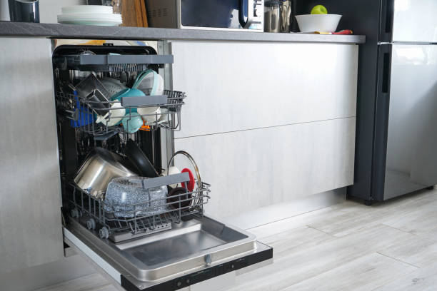 istock Dishwasher machine, open and loaded with dishes in the kitchen, after washing. 1223990698