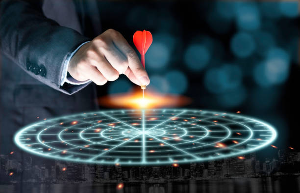 istock Businessman throwing red arrow dart to virtual target dart board. Setup objectives and target for business investment concept. 1223991402