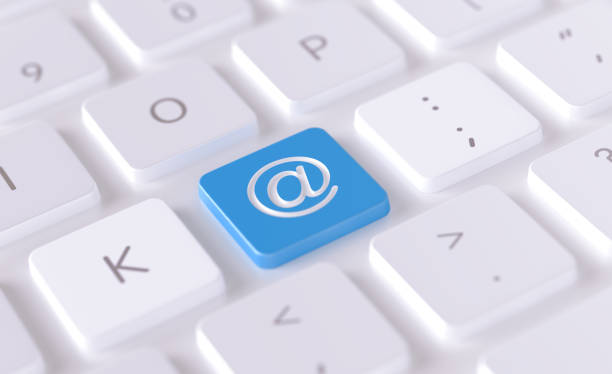 At symbol written on a blue button of a computer keyboard. Horizontal composition with selective focus and copy space. High angle view. Horizontal composition with copy space. Contact us via email concept.