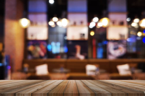 istock wooden table with abstract blurred background resturant lights used for display montage products mock up design. 1223991932