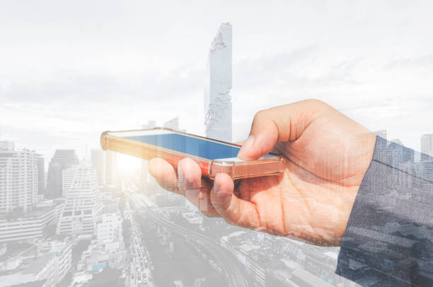 istock double exposure city and businessman using smartphone searching with internet online networking. device mock up mobile phone texting communication connecting. 1223991978