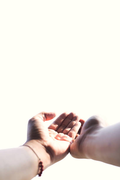 istock Soft focus human hands praying on isolated white background with sunlight,Spirituality with believe and religion,high key and high contrast image.Selective focus with copy space 1223995386