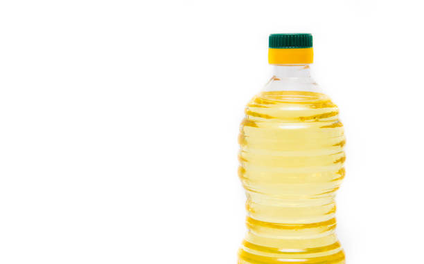 istock Bottle with vegetable oil on a white background. The bottle is half visible on the right side. Oil, refined, deodorized, refined. Bottle with a green  cap 1223995803