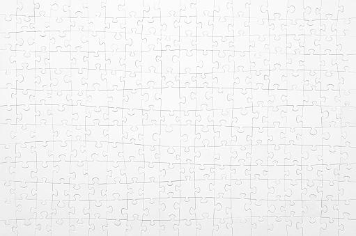White jigsaw puzzle. Horizontal on white background copy space for your text.