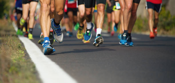 istock Marathon runners running on city road 1223997112