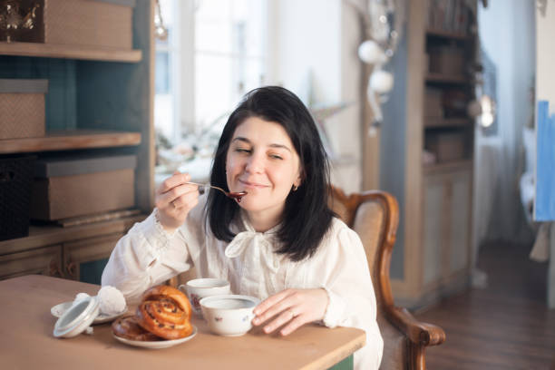istock A young woman has breakfast with tea and pastries with jam. 1223998101