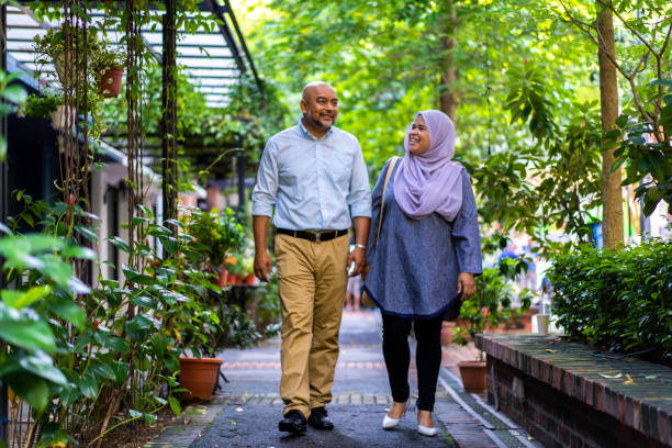 Young Asian Malay Father and Daughter taking a walk outdoors. Young Asian Malay Father and Daughter taking a walk outdoors. 

Location: Malaysia, Kuala Lumpur iStockalypse KL happy malay couple stock pictures, royalty-free photos & images